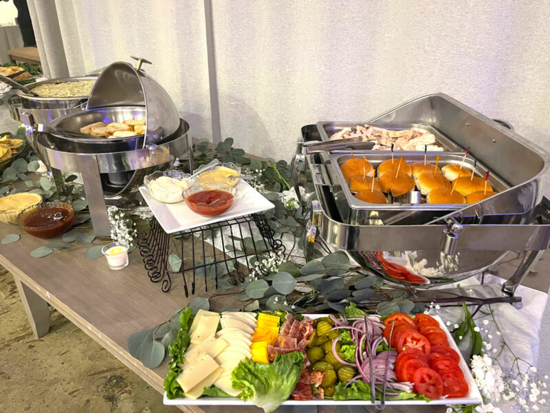 A buffet table with a variety of food on it.