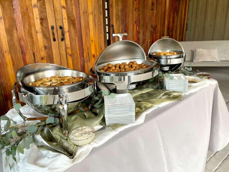 A buffet table with a variety of food on it.