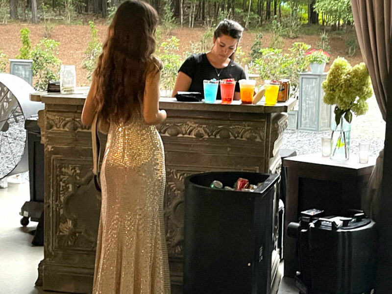 A man and woman standing at a bar.