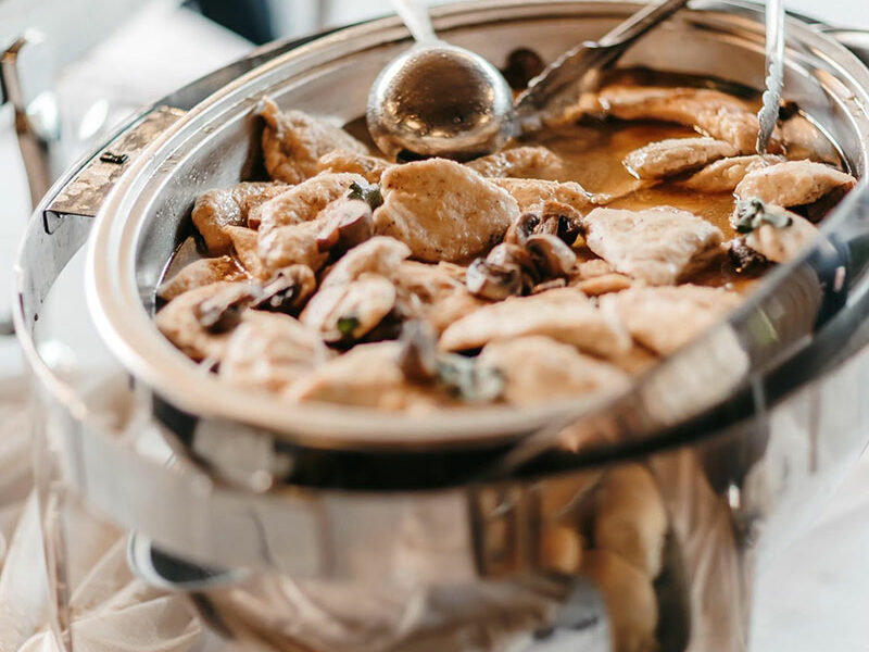 A platter of food on a table at a wedding.