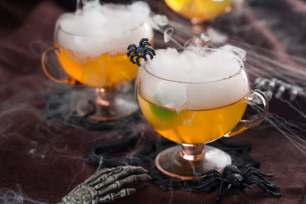 A spooky party drink with a spider on top to impress guests.