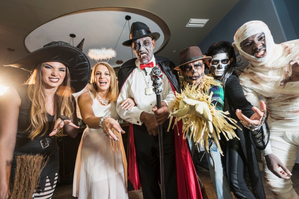 A group of people in spooky Halloween costumes at a party.