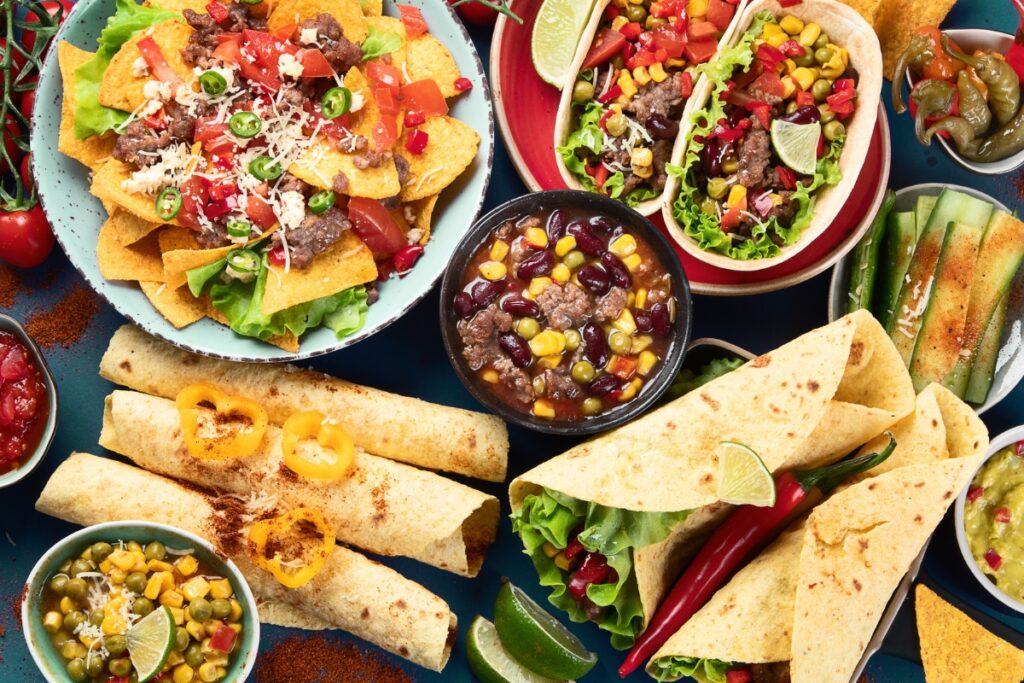 A variety of mexican food on a blue background, adding a touch of Thanksgiving traditions.