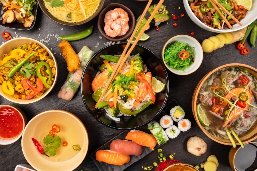 A variety of Asian food, inspired by Thanksgiving traditions, presented in bowls on a table.