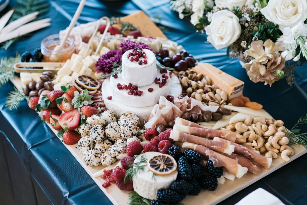 An appetizing platter of assorted cheese and fresh fruit arranged beautifully on a table, perfect for buffet food ideas.