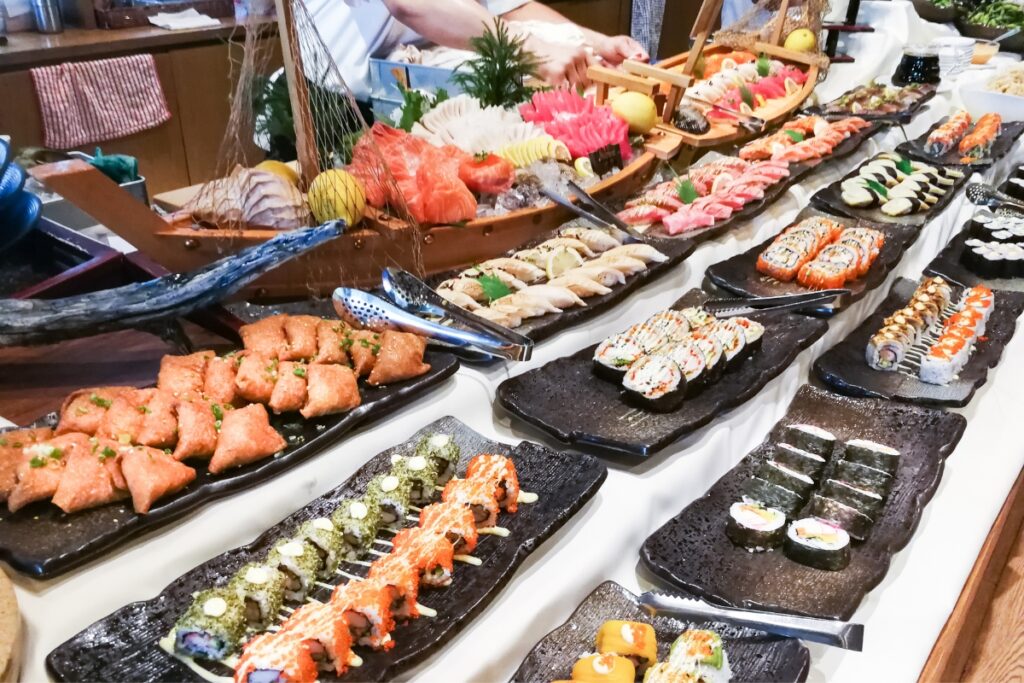 A diverse sushi bar offering a wide selection of buffet food ideas.