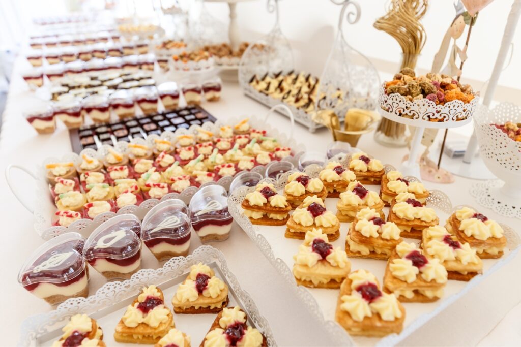 A table with trays of desserts, perfect for dessert catering at parties.