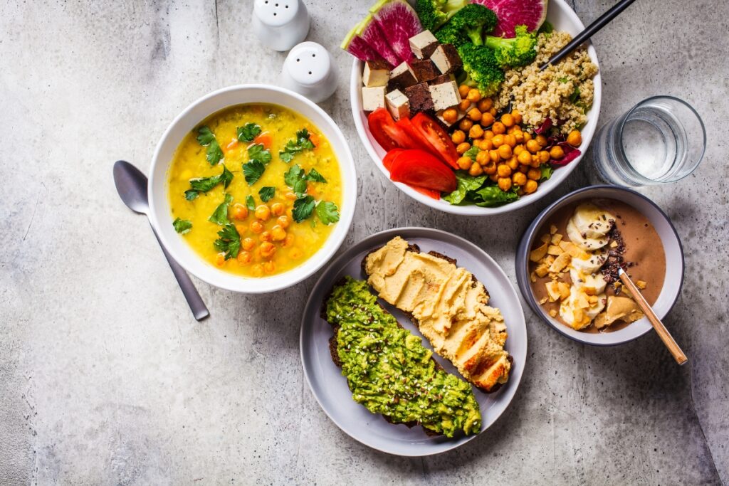 A variety of plant-based bowls of food on a table, showcasing our delicious vegan menus.