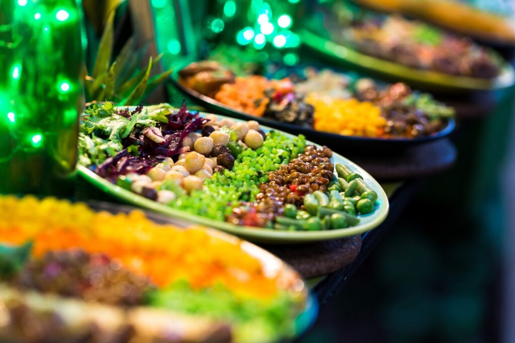 A plate of plant-based food on a table at a vegan catering event.