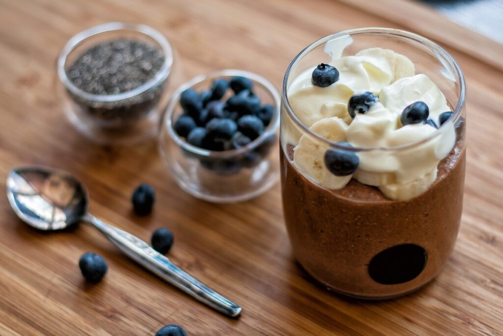 Vegan chocolate mousse with blueberries and whipped cream.
