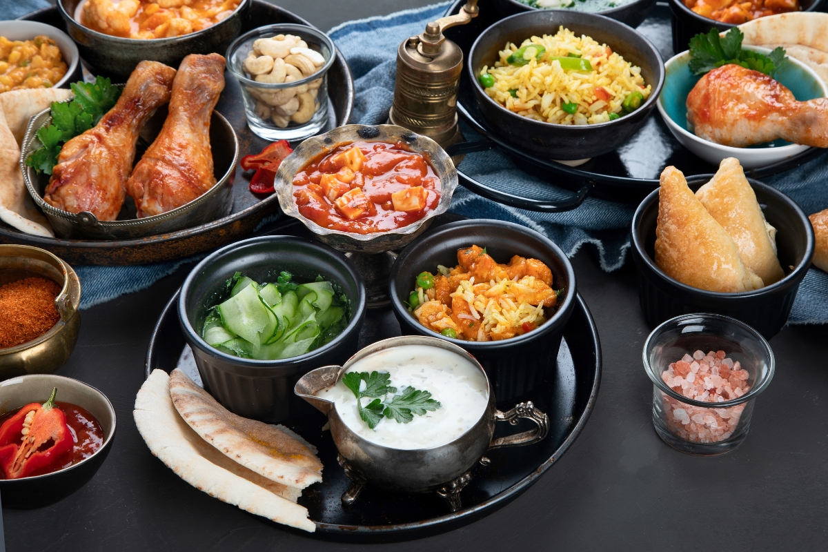 A variety of Indian food, expertly arranged for food styling, on a table.